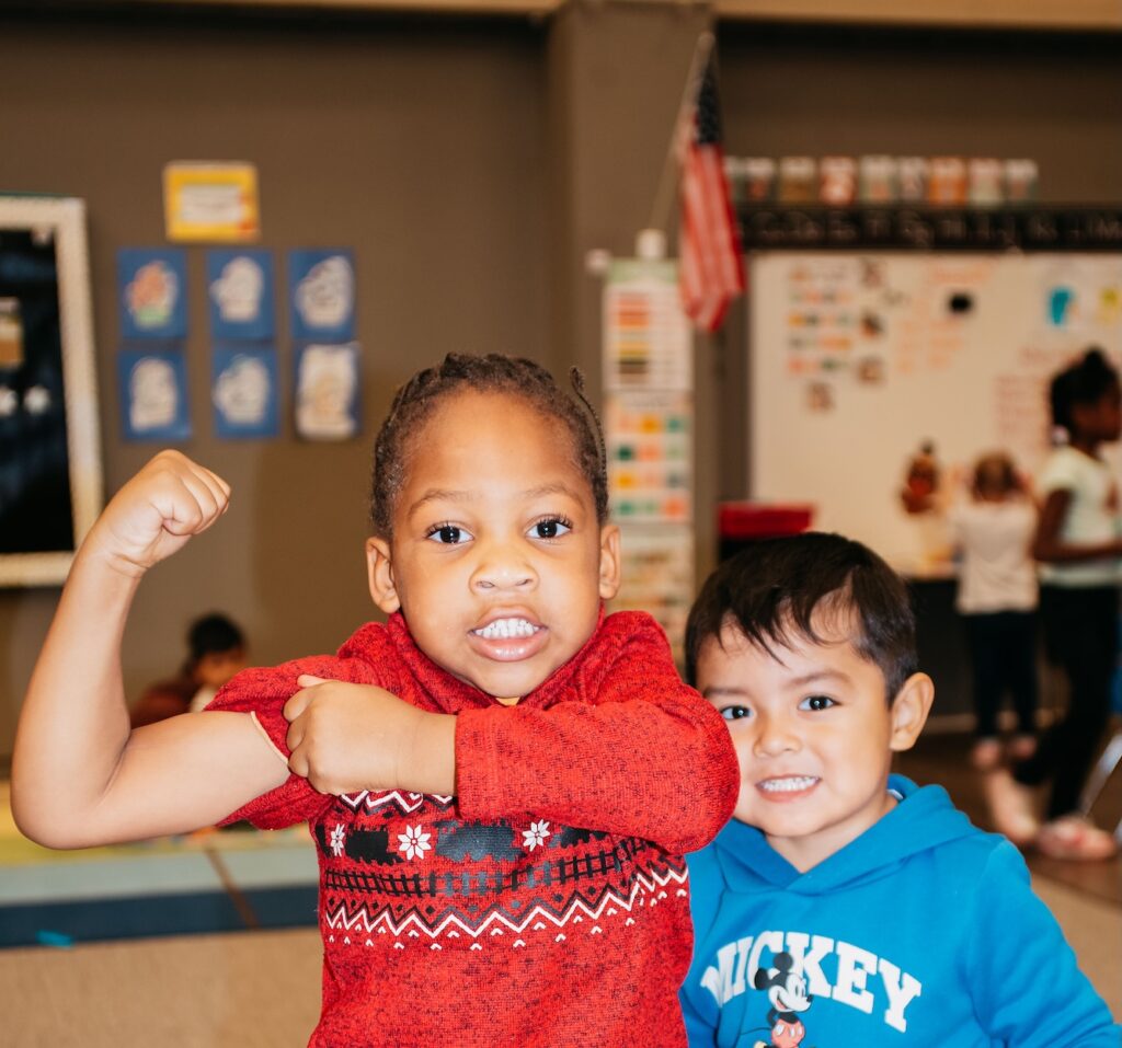 4-5 years old children smiling and posing for the camera in a Transitional Pre-K Program.